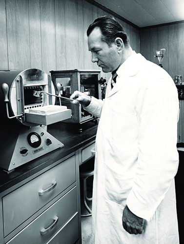 DDW Scientist in the lab with caramel color during the 1960s history